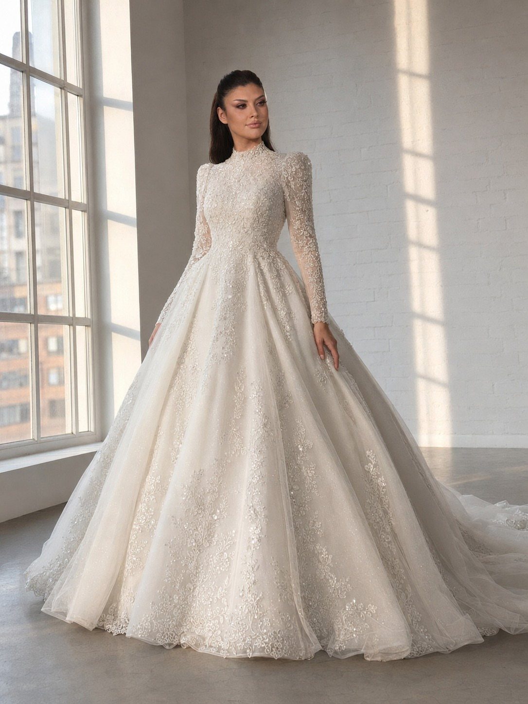 Woman in a white long sleeve lace wedding gown standing in a bright room