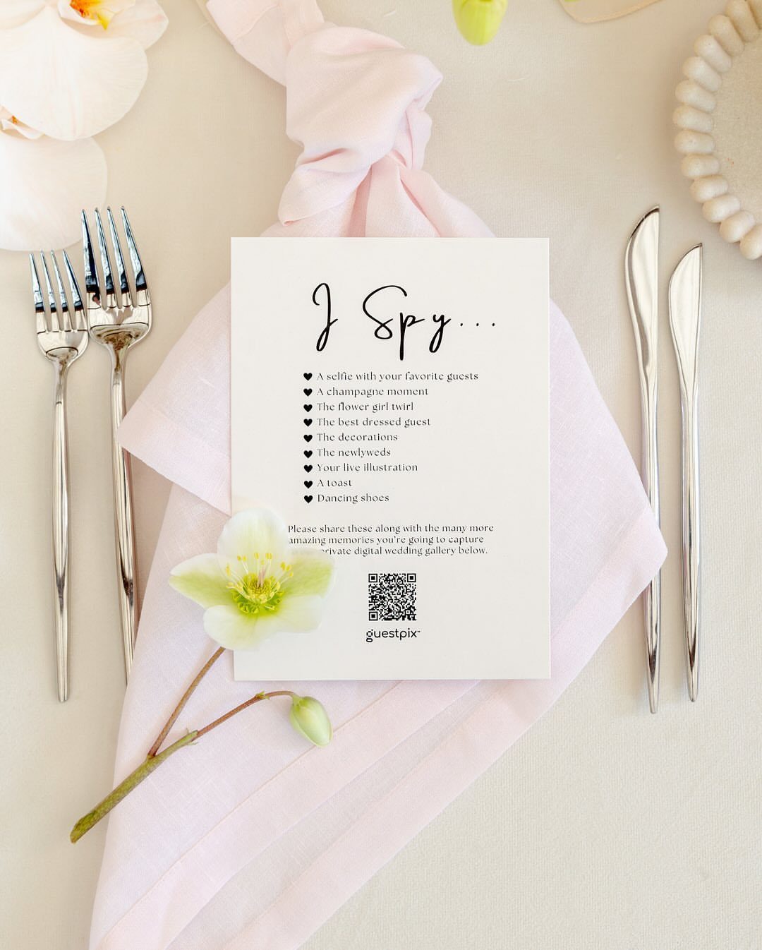 Wedding I Spy game card with QR code on a pink napkin with cutlery