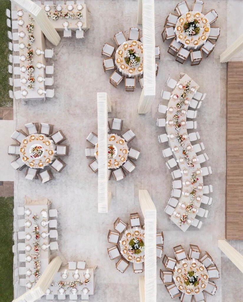 Overhead view of wedding reception table placements with round and curved seating arrangements.